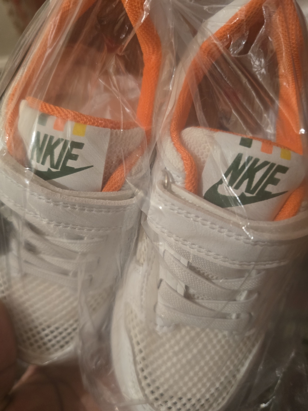 Nike Kids White Sneakers with Orange Accents and Green Logo